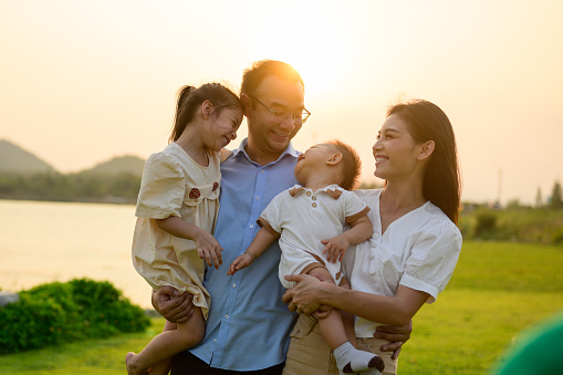 Smiling portrait of happy family enjoying with outdoor activities travel together on vacation, Family with happiness, Father mother and children enjoying picnic at park, Family with happy lifestyle