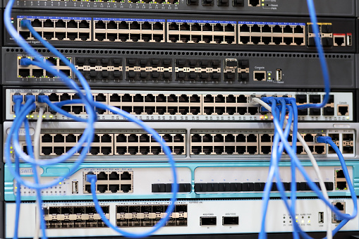 Racks with network equipment and patch cord cables. Selective focus.