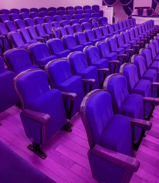 istock An empty modern cinema or conference room with rows of chairs, neon tinting 1490715954