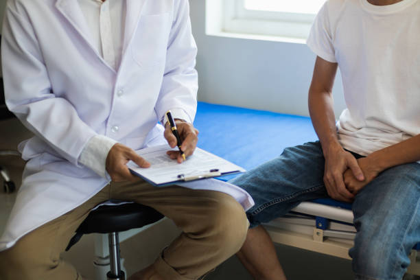 doctor is having consultation discussing prostate cancer and venereal cancer detected in young man. current doctors provide advice and counseling on detecting prostate cancer and treating it properly. - venereal imagens e fotografias de stock