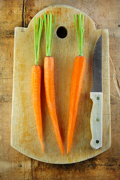 istock Carrots and Knife on Cutting Board 149071651