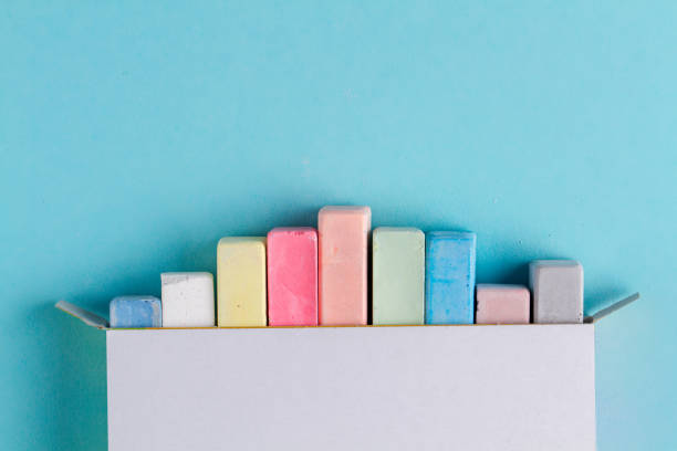 Colorful crayons for drawing on a blue background. Top view. Copy space. Color chalk