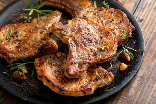 istock Pork chops grilled or seared bone in on a serving plate 1490718056