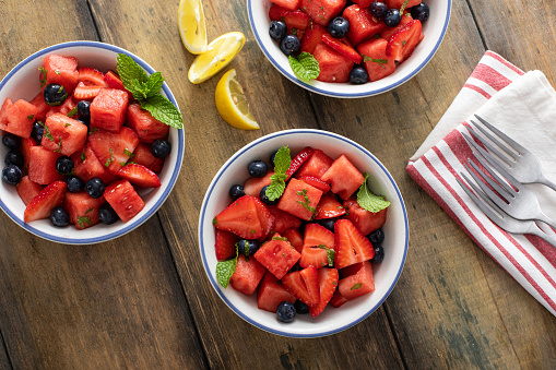 Fruit salad with watermelon and berries with fresh mint and lemon juice dressing