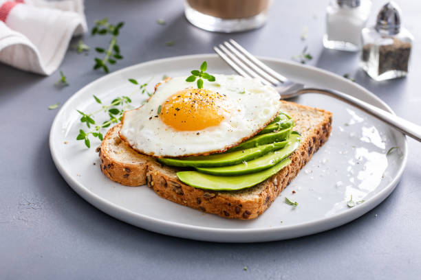 istock Wholegrain avocado toast with fried egg on top 1490718107
