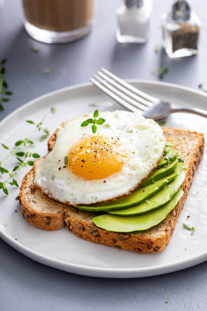 istock Wholegrain avocado toast with fried egg on top 1490718111