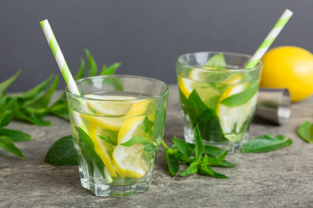 istock Mojito summer refreshing cocktail with ice and mint. mojito cocktail with lime, lemon and mint in a tall glass with a stick 1490718879