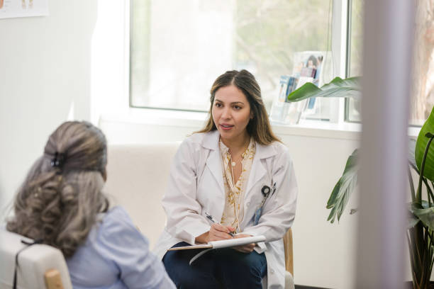 istock Serious female psychiatrist takes notes during session with female client 1490719794