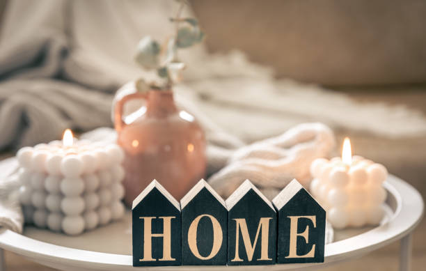 istock Cozy composition with decorative word home, candles and vase on blurred background. 1490720342