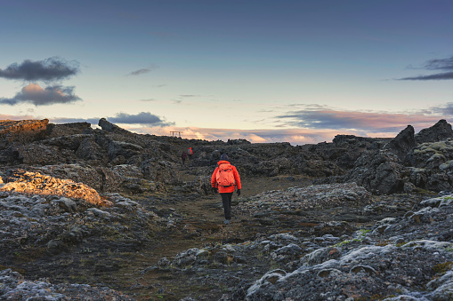 Group of backpacker walking on lava field in remote wilderness on summer at Iceland