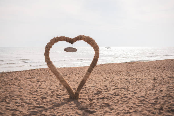 Wedding ceremony arch by the sea on sunset