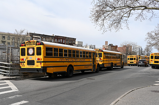 New York, USA, April 11, 2023 - Several yellow school buses aderjüdische private school Yeshiva Bnos Ahavas Israel in South Williamsburg - Brooklyn.