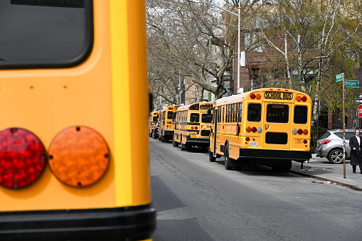 New York, USA, April 11, 2023 - Several yellow school buses aderjüdische private school Yeshiva Bnos Ahavas Israel in South Williamsburg - Brooklyn.