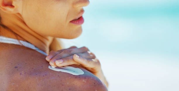 istock Closeup on young woman applying sun screen creme 1490726316