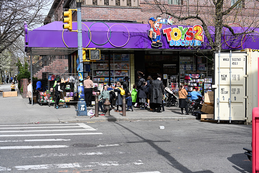 New York, USA, April 11, 2023 - Unidentified Jewish families in front of Toys 2 Discover toy store on Lee Ave, South - Williamsburg, Brooklyn , New York.