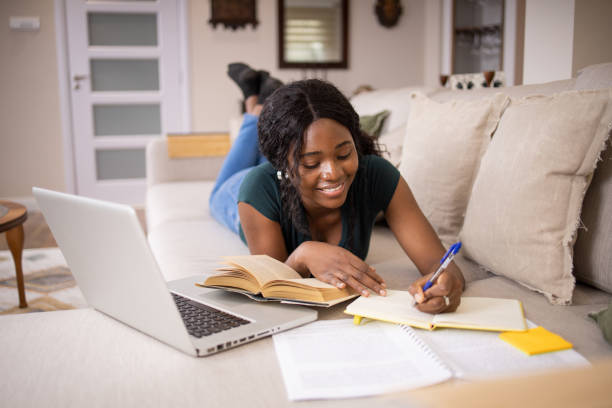 istock Happy young woman is learning at home 1490728541
