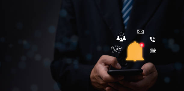 istock Businessman holding smart phone with virtual bell ringing for notification alert concept. social media and internet network, email, telephone, chat, shopping online. 1490728670