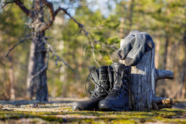 Trekking boots and socks dry in the sun in the forest.