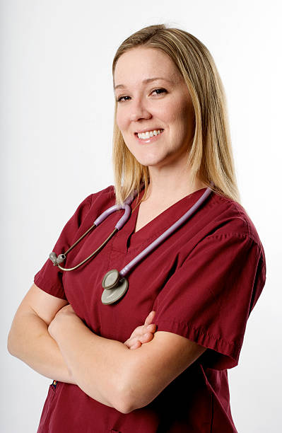 Happy Young Medical Professional Happy Young Medical Professional in scrubs on white red medical scrubs stock pictures, royalty-free photos & images