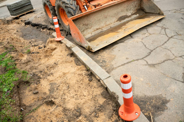 istock Construction of a footpath. Laying granite tiles on sandy ground and replacing sewer hatches. Improvement of urban areas and renewal of infrastructure 1490731884