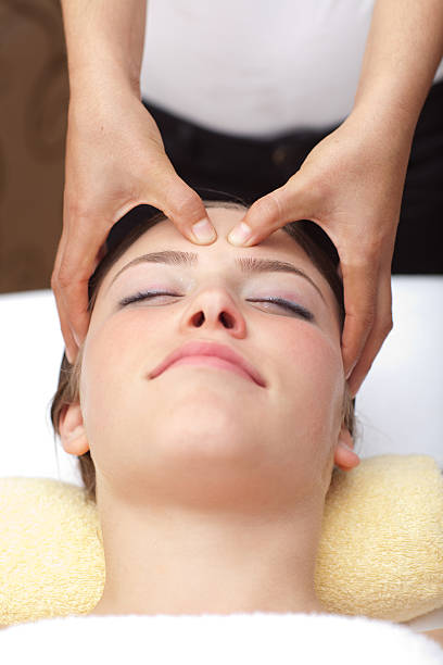 Young woman receiving head massage stock photo