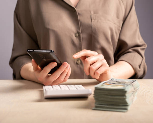 istock Calculating costs, expenses, savings with calculator and smartphone 1490734500