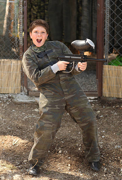 Boy with paintball gun stock photo