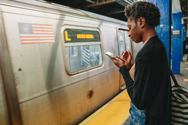 istock A woman is using a smartphone while she's waiting for the train in a subway station 1490736415