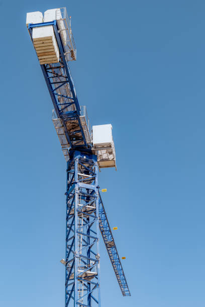 istock High-rise construction crane with a long blue boom against the blue clear sky 1490736601