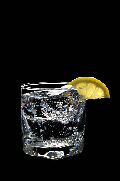 Club Soda or Vodka Tonic Cocktail on black background stock photo