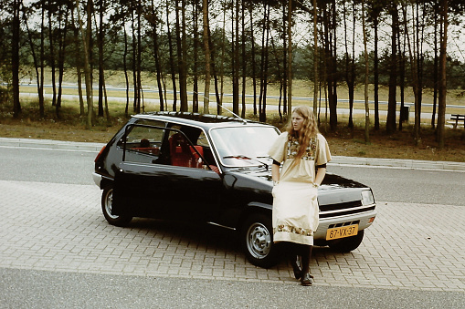 Young woman with her car, back in the 1970's