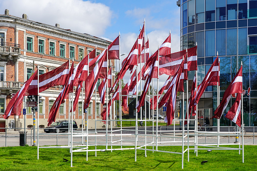 Many national flags of Latvia waving on public holidays in the city square