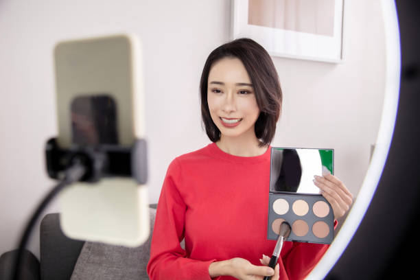 istock Young Asian woman live streaming to teaching make up online 1490747549