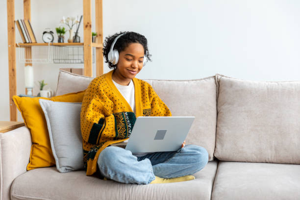 istock African american girl using laptop at home office looking at screen typing chatting reading writing email. Young woman having virtual meeting online chat video call conference Work learning from home 1490749725