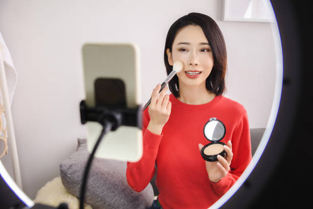 istock Young Asian woman live streaming to teaching make up online 1490751142