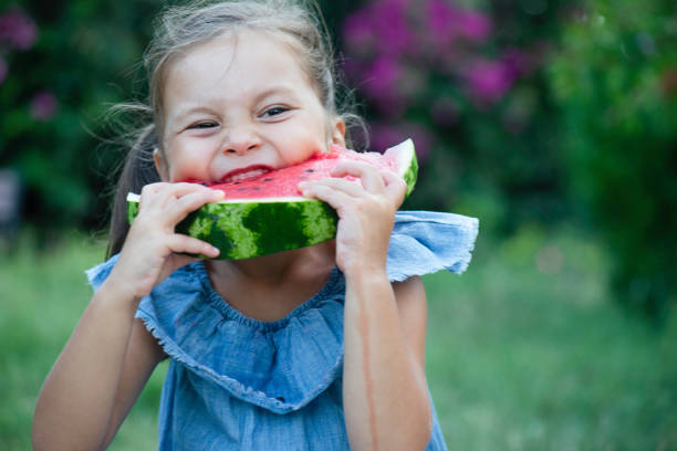 istock Little Girl Eating Watermelon 1490751800