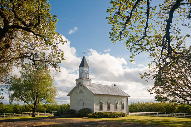 A beautiful old white rural Church in a field Old clapboard white rural church in Willamette Valley, Oregon, Oak Grove steeple stock pictures, royalty-free photos & images