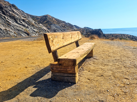 Wooden seat facing the sea
