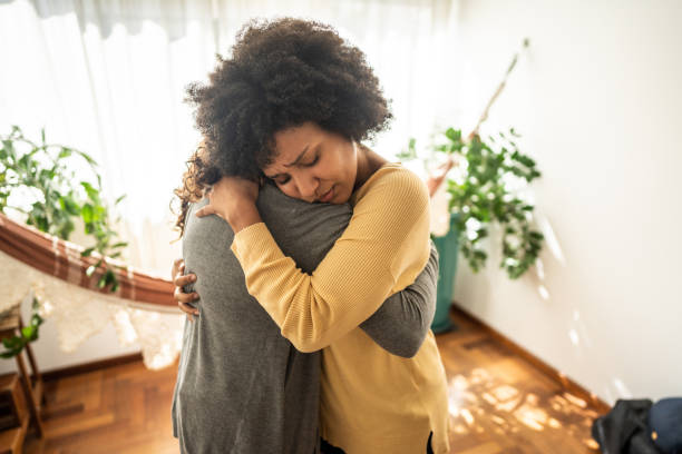 istock Sad young woman embracing her girlfriend at home 1490754300