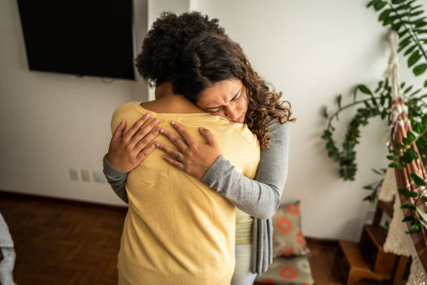 istock Sad young woman embracing her girlfriend at home 1490754325