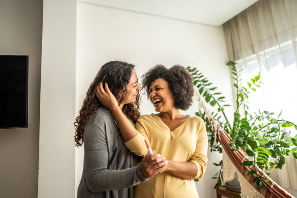 istock Lesbian couple holding a pregnancy test at home 1490754497