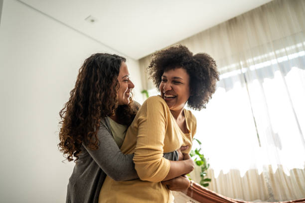 istock Happy lesbian couple embracing at home 1490754500