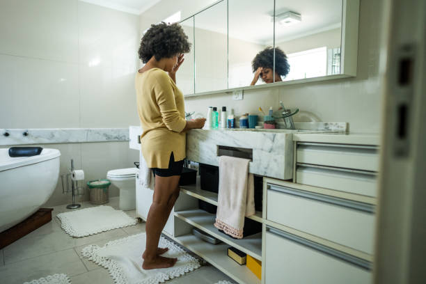 istock Sad young woman looking a pregnancy test on bathroom at home 1490754590