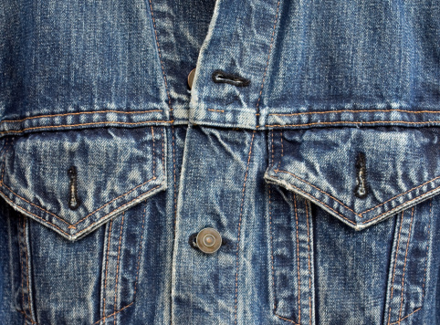 closeup detail of vintage denim jacket pockets