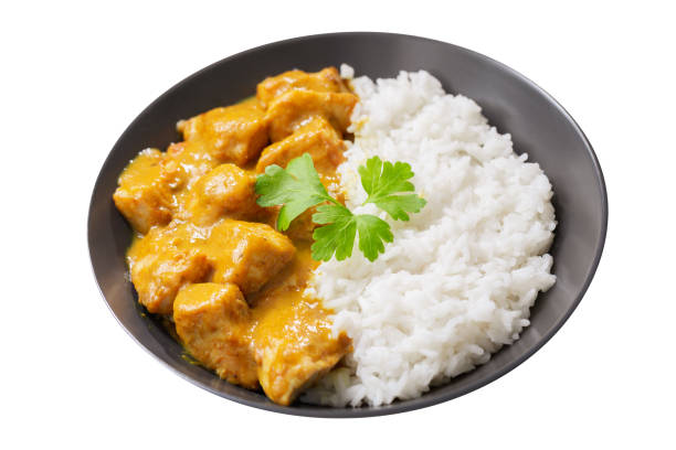istock plate of chicken with curry sauce and rice on white background 1490755500