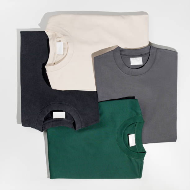 istock Plain t-shirts assorted colors with blank label. T-shirts isolated on a white background. Space for logo. Mockup 1490755927