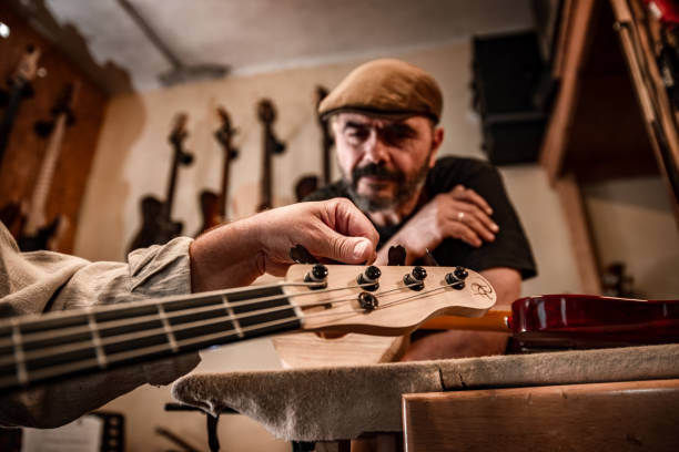 istock Musician tuning his new custom-made bas guitar 1490758686