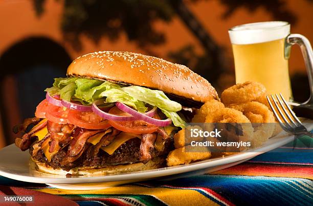 Giant Bacon Cheese Burger With Onion Rings And Beer Stock Photo - Download Image Now