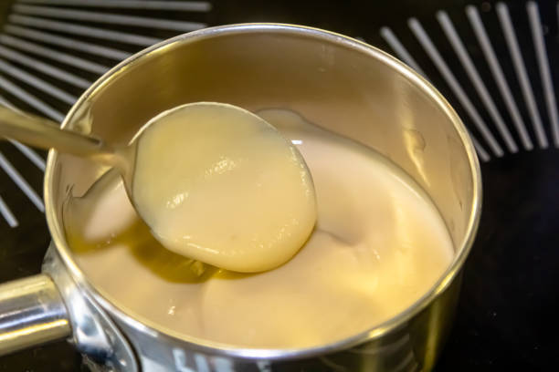 istock A chief cooking from a stainless steel saucepan in a professional luminous kitchen 1490761828