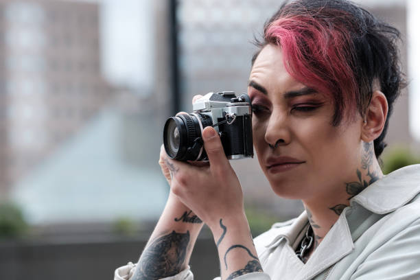 istock Portrait of non-binary male androgynous taking an analog picture. 1490764102